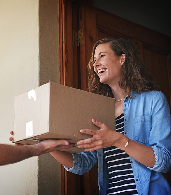 A woman receiving a package at her door.